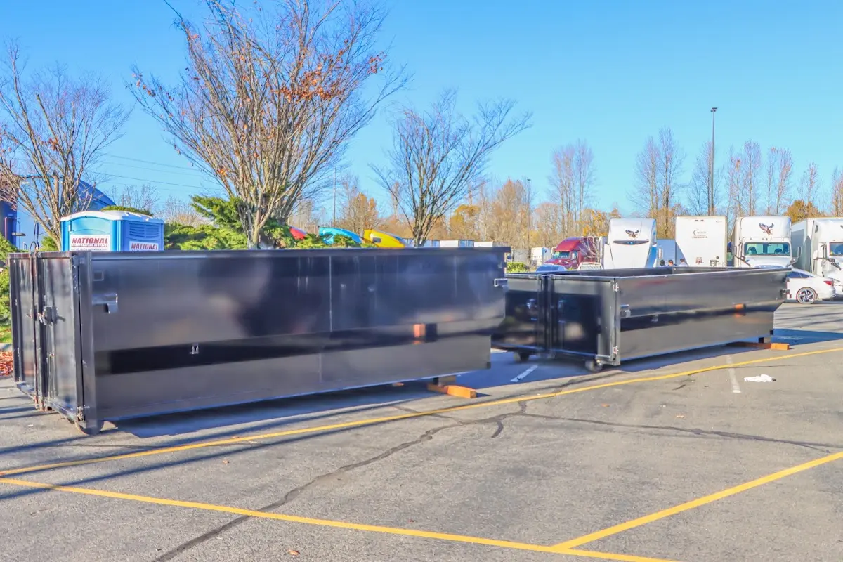 Professional dumpster rental service with roll-off container on residential driveway in Upper Providence